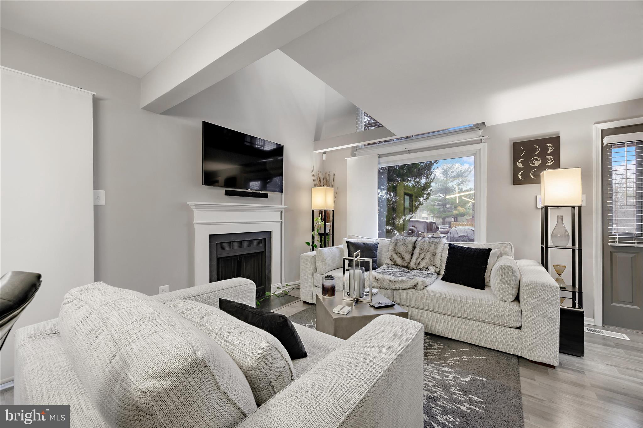 7314 Split Rail Lane Laurel, MD 20707 - Photo 8 of 32 a living room with furniture a flat screen tv and a fireplace