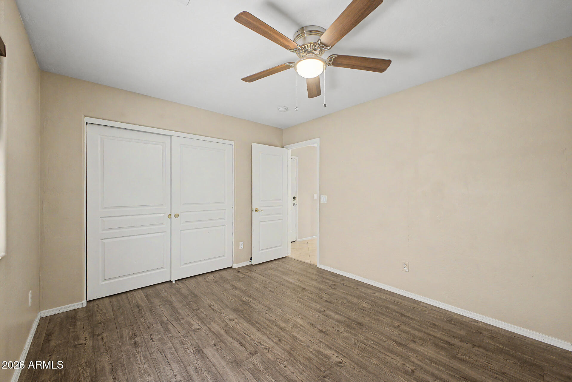 2340 West Apollo Road Phoenix, AZ 85041 - Photo 15 of 26 wooden floor in an empty room