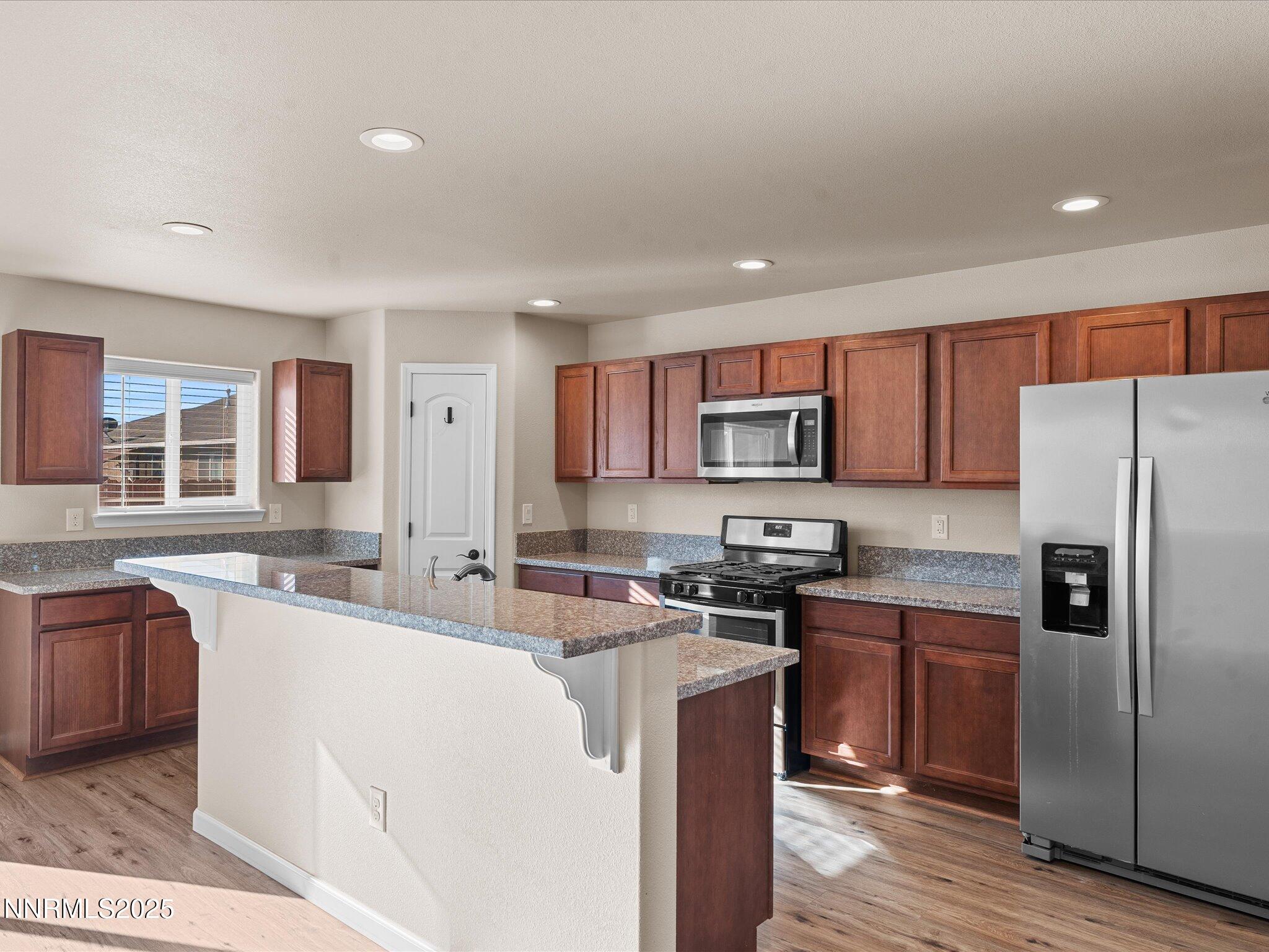 2541 Milano Way Fallon, NV 89406 - Photo 13 of 47 a kitchen with stainless steel appliances granite countertop a sink stove refrigerator and cabinets