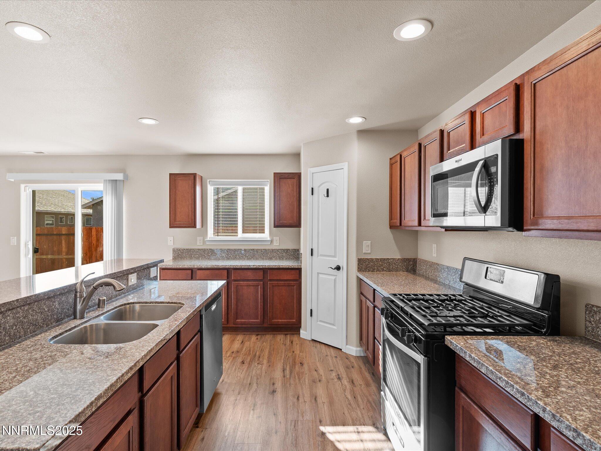 2541 Milano Way Fallon, NV 89406 - Photo 15 of 47 a kitchen with stainless steel appliances granite countertop a sink stove and cabinets