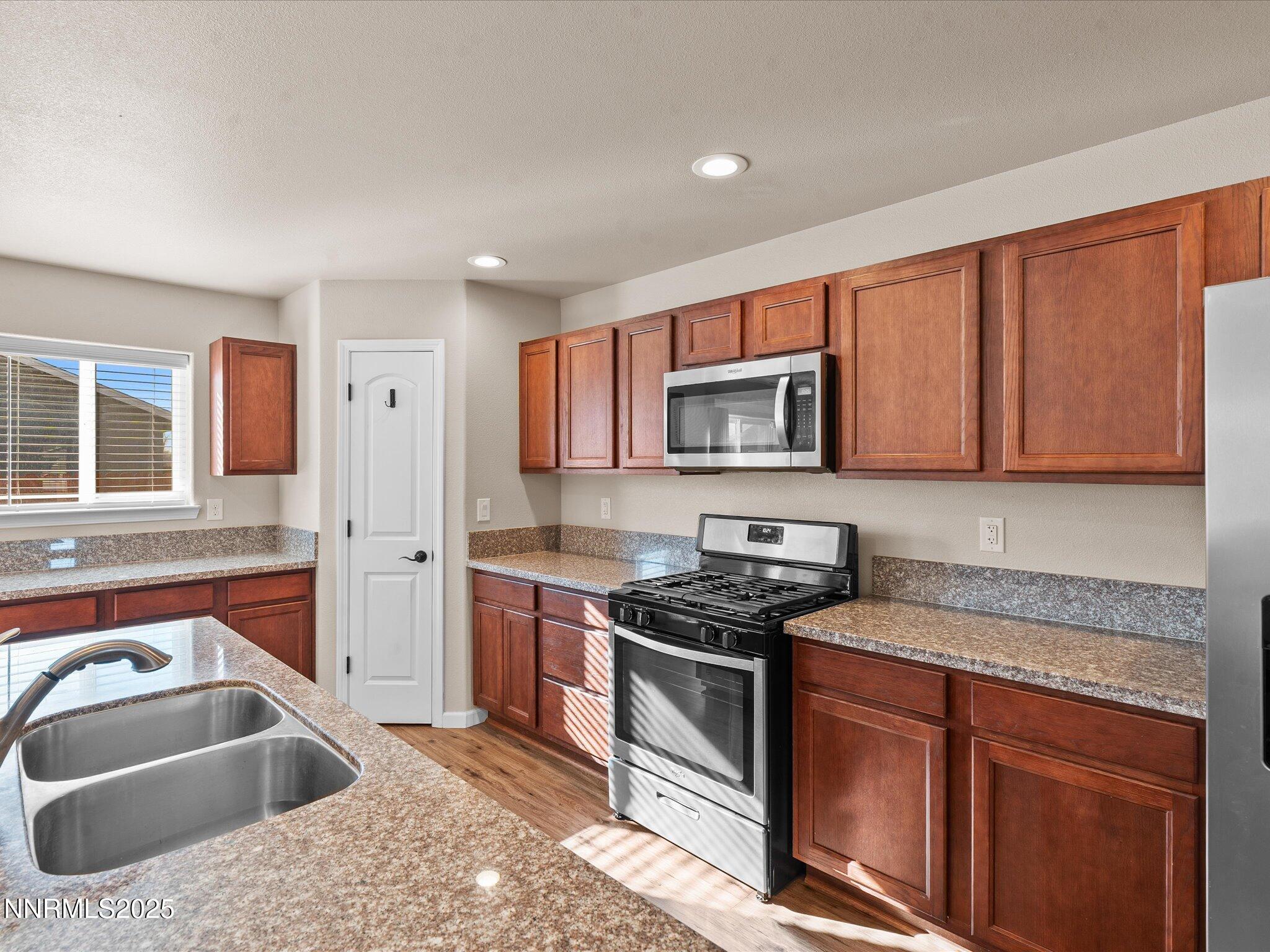 2541 Milano Way Fallon, NV 89406 - Photo 16 of 47 a kitchen with stainless steel appliances granite countertop a sink stove and cabinets