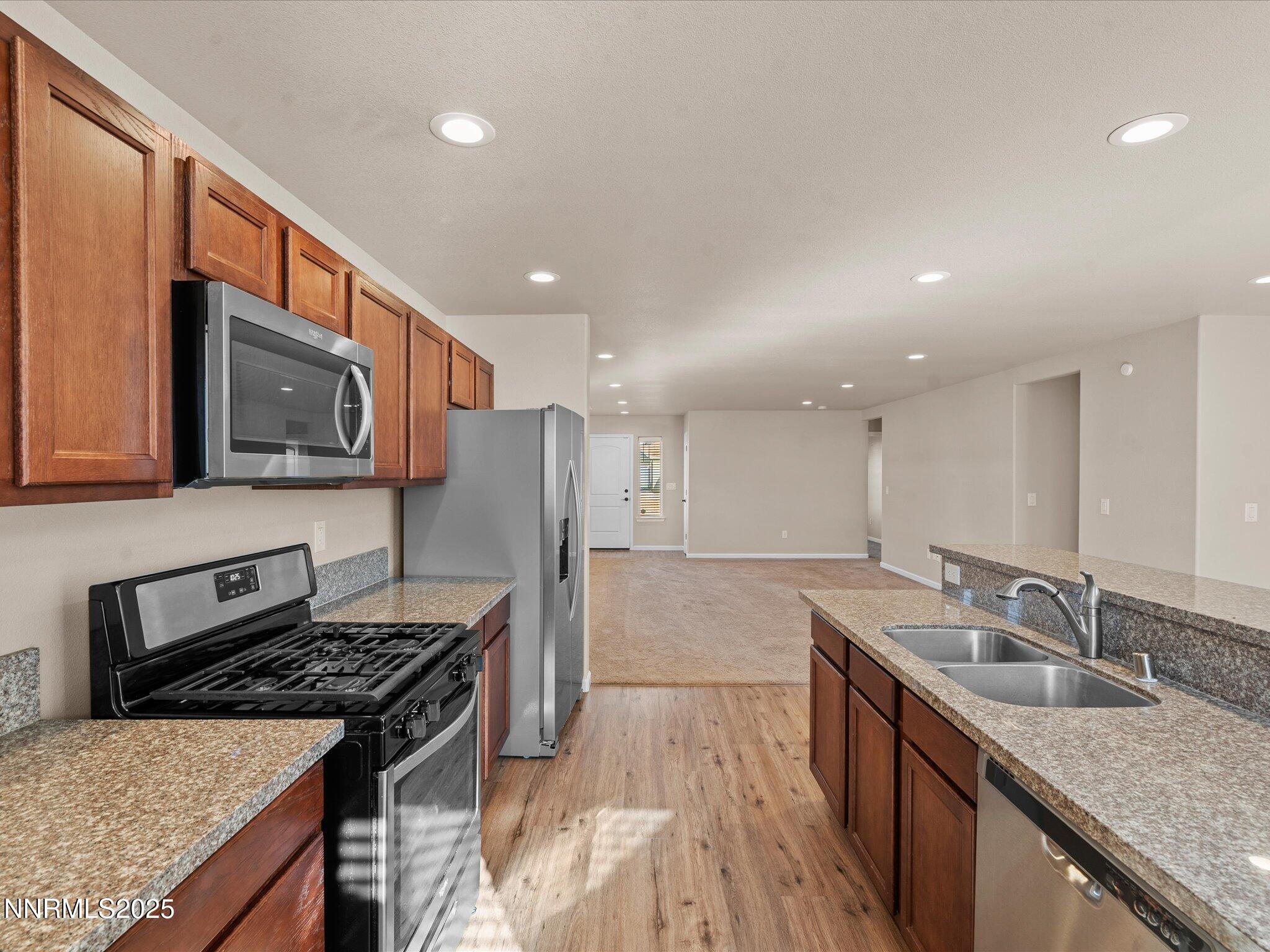 2541 Milano Way Fallon, NV 89406 - Photo 17 of 47 a kitchen with stainless steel appliances granite countertop a sink stove and refrigerator
