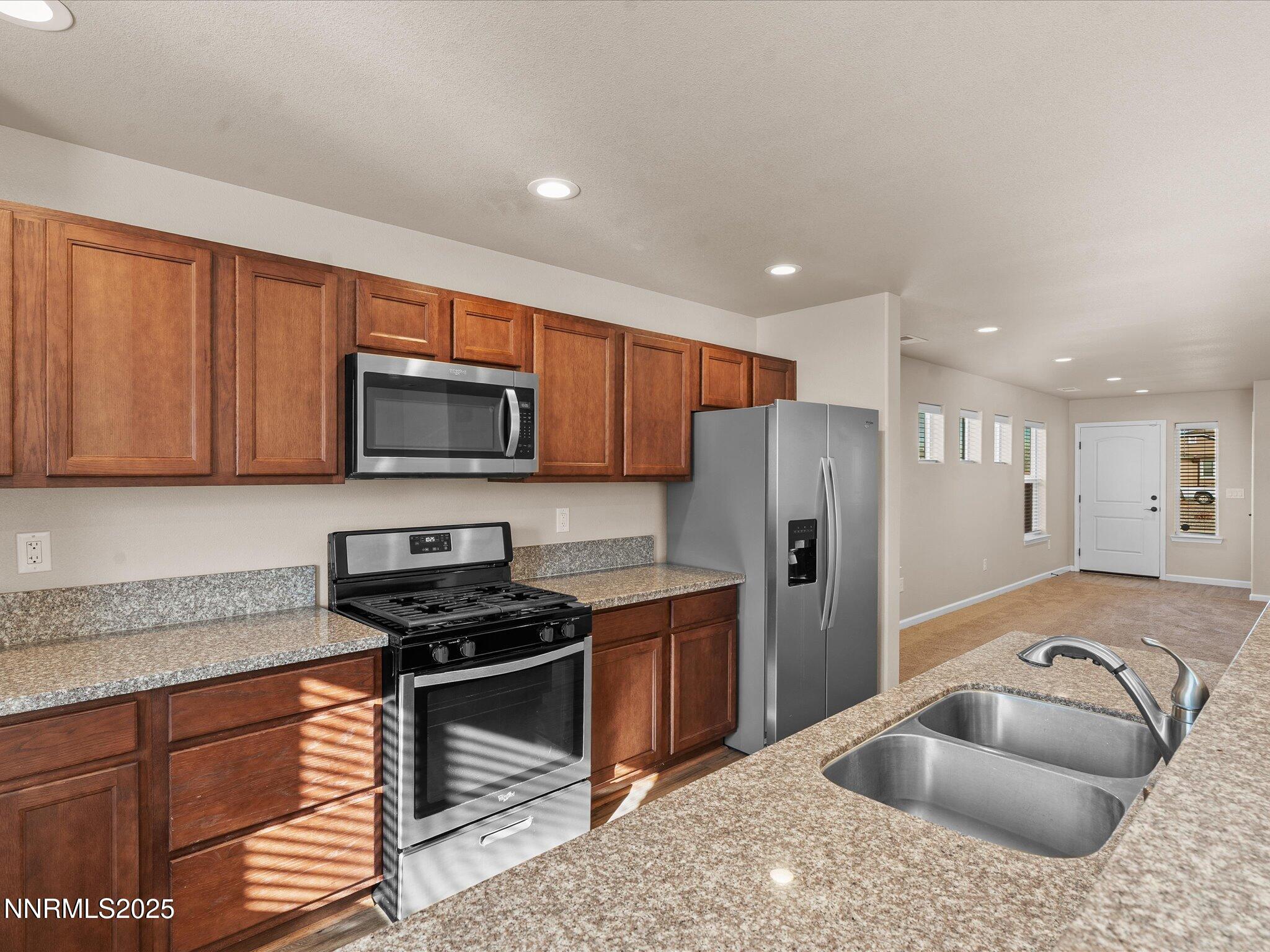 2541 Milano Way Fallon, NV 89406 - Photo 18 of 47 a kitchen with stainless steel appliances granite countertop a refrigerator stove microwave and sink