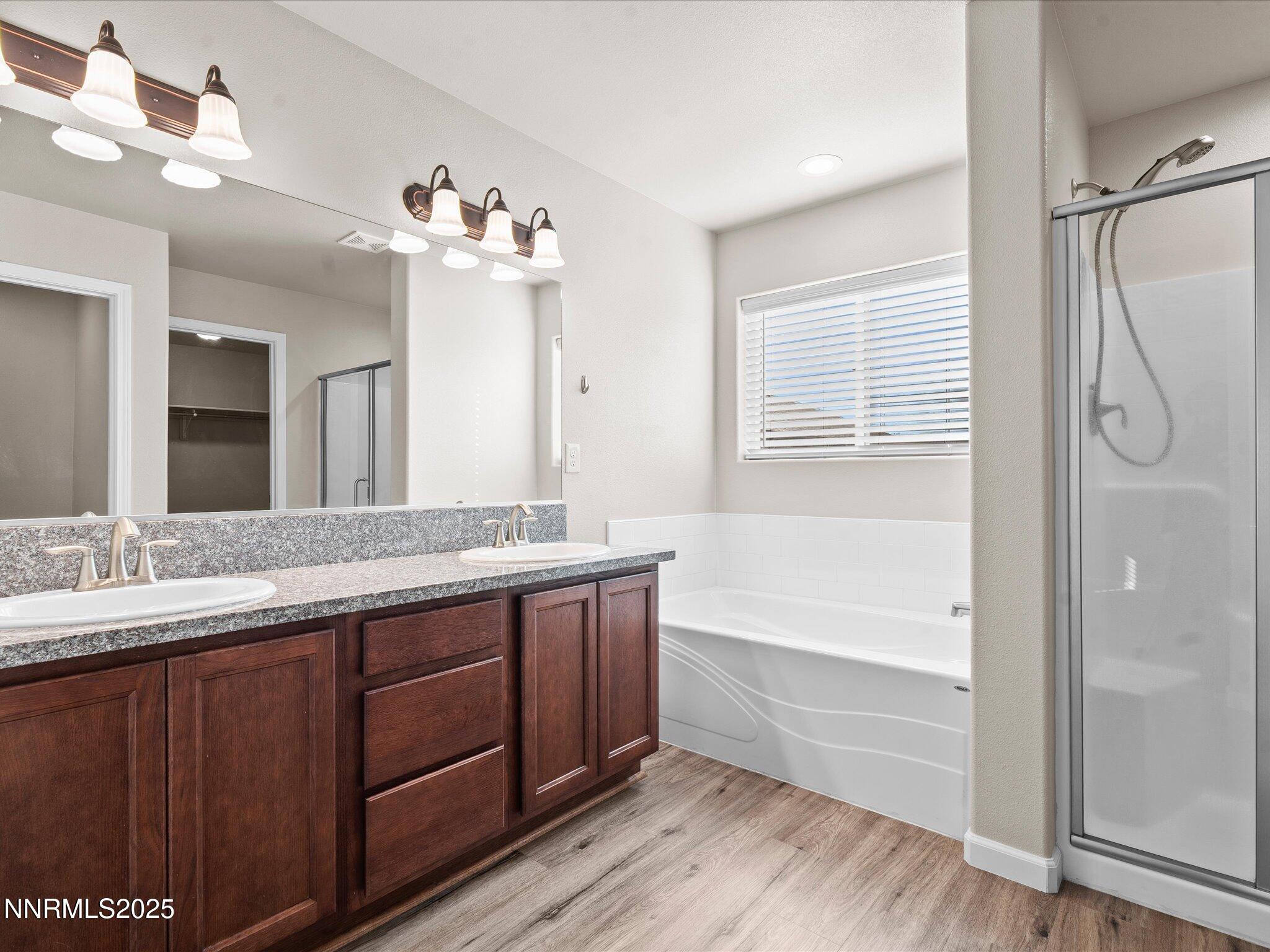 2541 Milano Way Fallon, NV 89406 - Photo 22 of 47 a bathroom with a bathtub double vanity sink and mirror