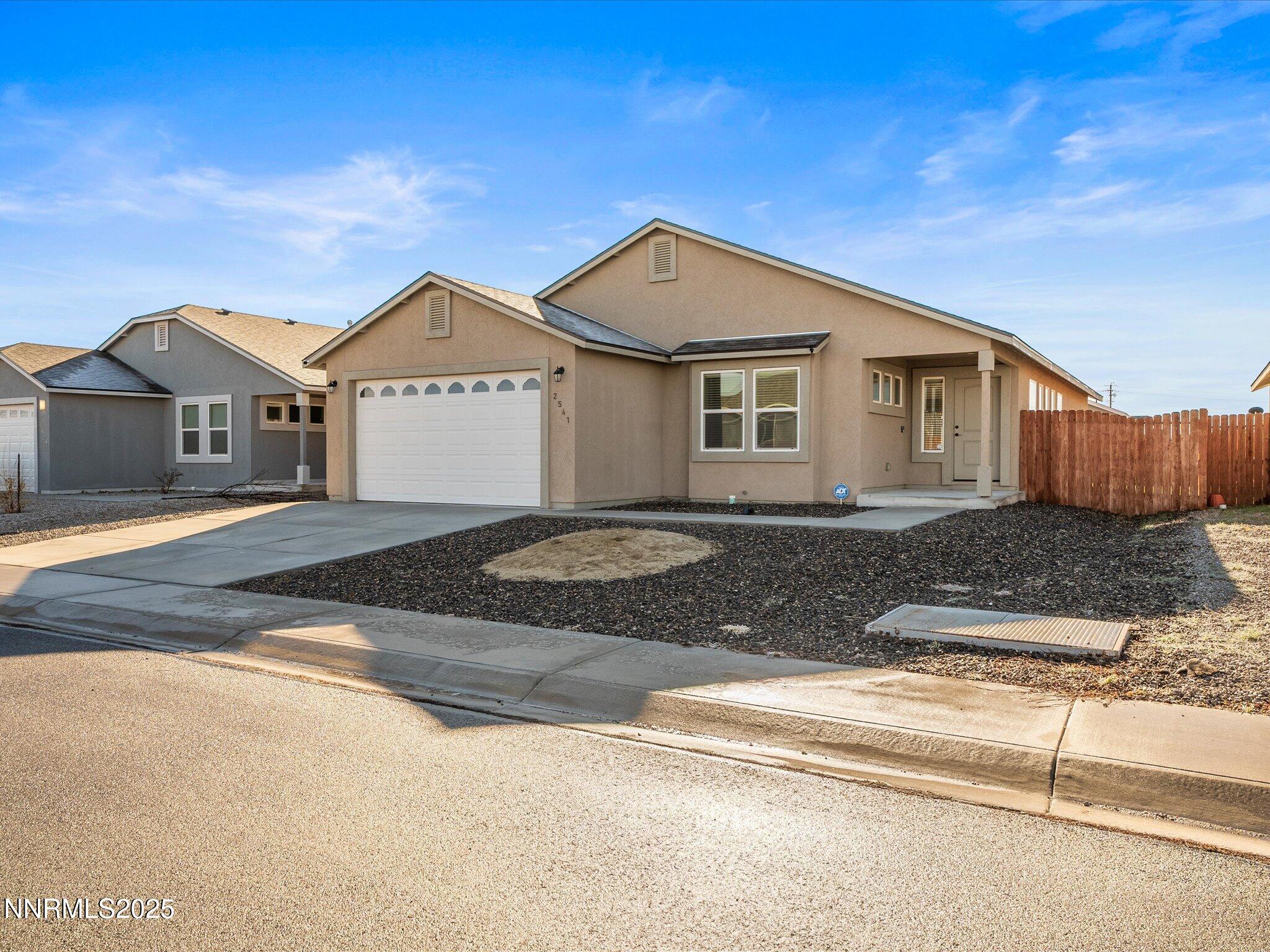 2541 Milano Way Fallon, NV 89406 - Photo 3 of 47 a front view of a house with a yard