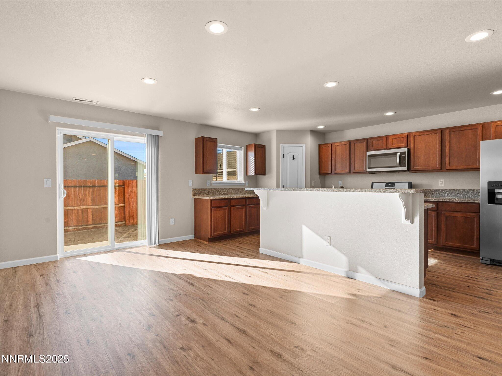 2541 Milano Way Fallon, NV 89406 - Photo 9 of 47 a large kitchen with wooden floors and stainless steel appliances