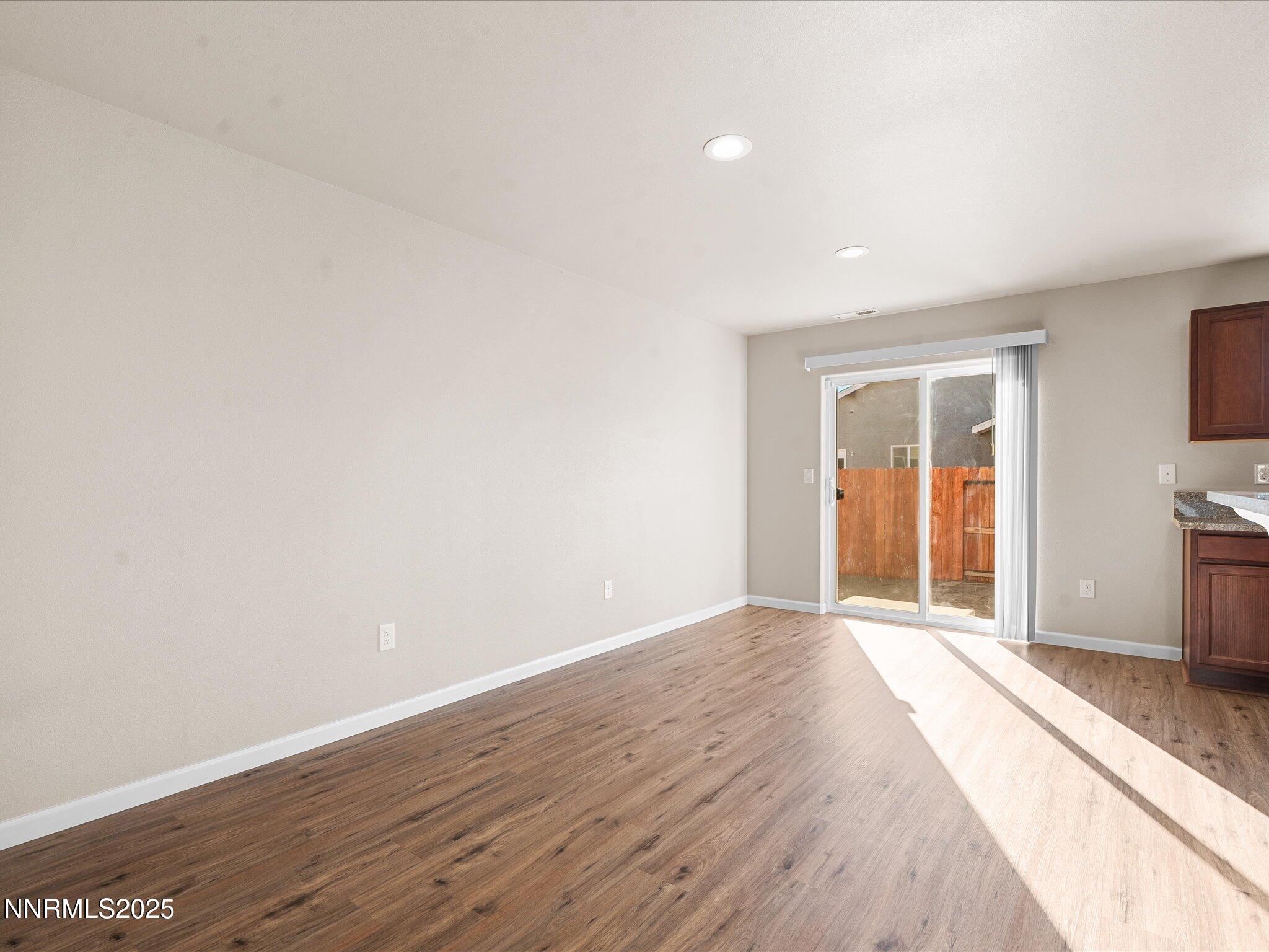 2541 Milano Way Fallon, NV 89406 - Photo 10 of 47 a view of an empty room with wooden floor and a window