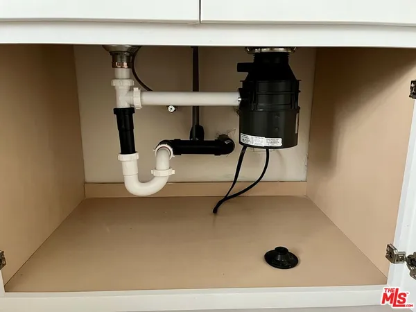 a kitchen with a sink a stove and a refrigerator