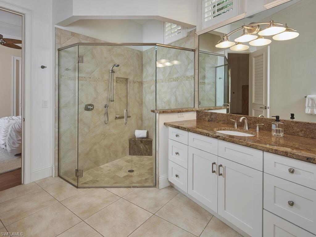 377 Pirates Bight Naples, FL 34103 - Photo 31 of 44 a bathroom with a granite countertop sink mirror and shower