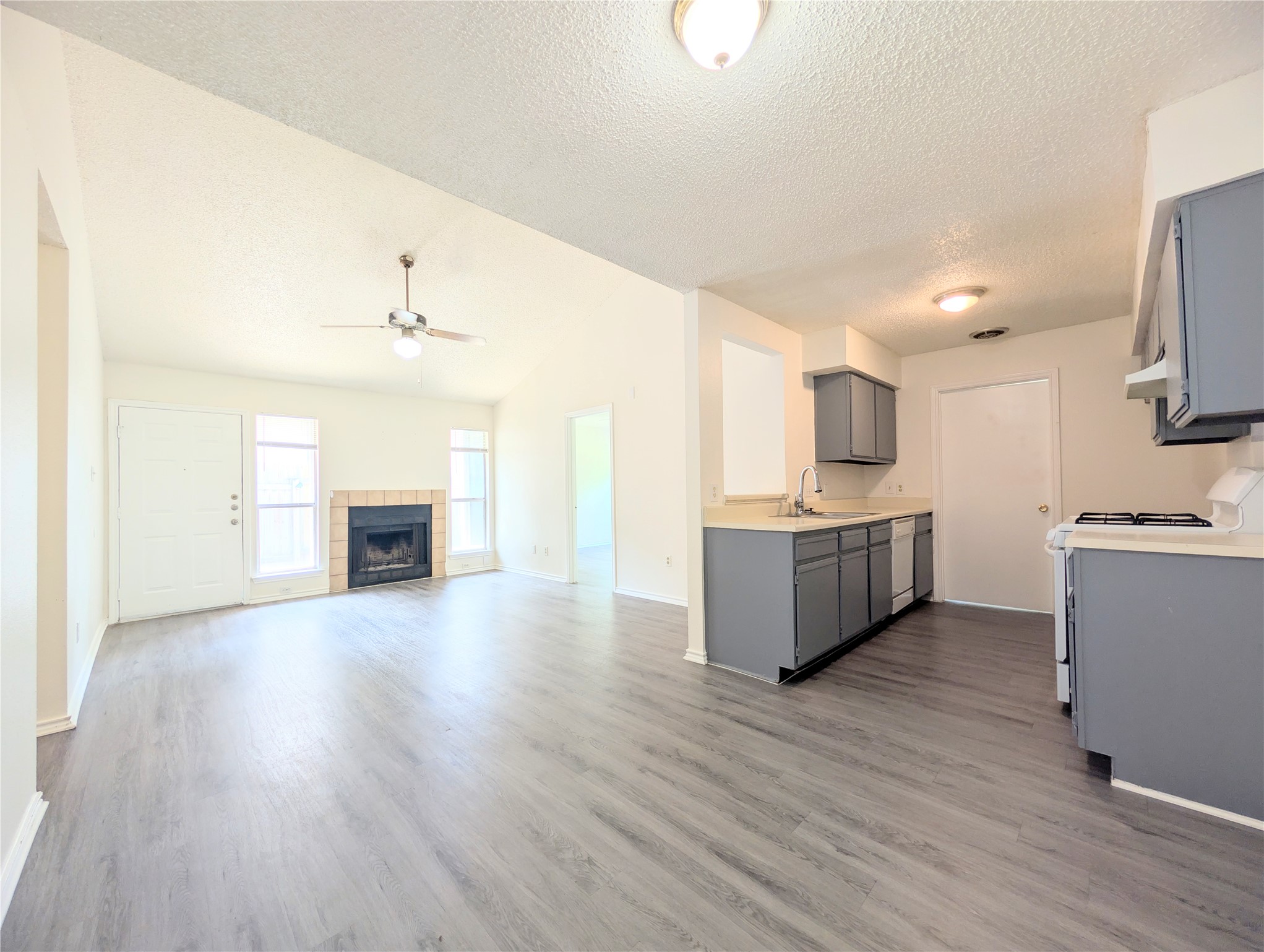 2036 Redwing Way Round Rock, TX 78664 - Photo 9 of 23 An inviting open-concept living space features high vaulted ceilings and a cozy corner fireplace.