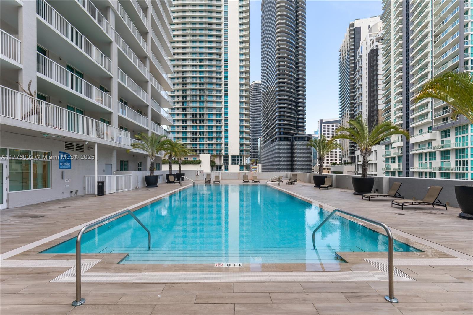 1250 South Miami Avenue, Unit 1206 Miami, FL 33130 - Photo 19 of 19 a view of a swimming pool with a lounge chairs