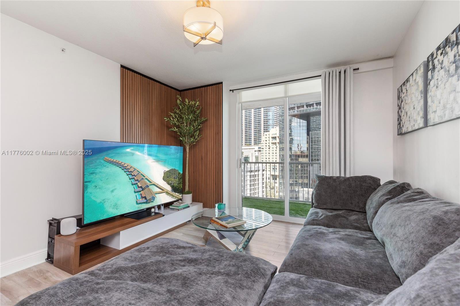 1250 South Miami Avenue, Unit 1206 Miami, FL 33130 - Photo 7 of 19 a living room with furniture flat screen tv and a large window
