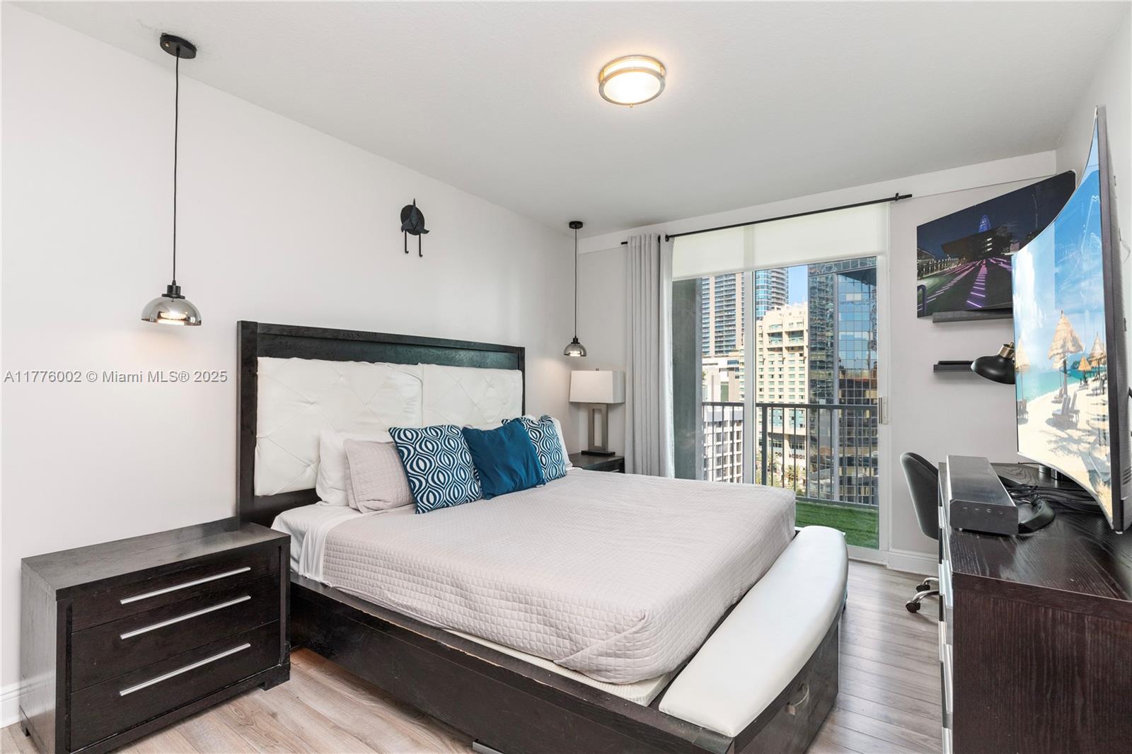 1250 South Miami Avenue, Unit 1206 Miami, FL 33130 - Photo 8 of 19 a bedroom with a bed wooden floor and window