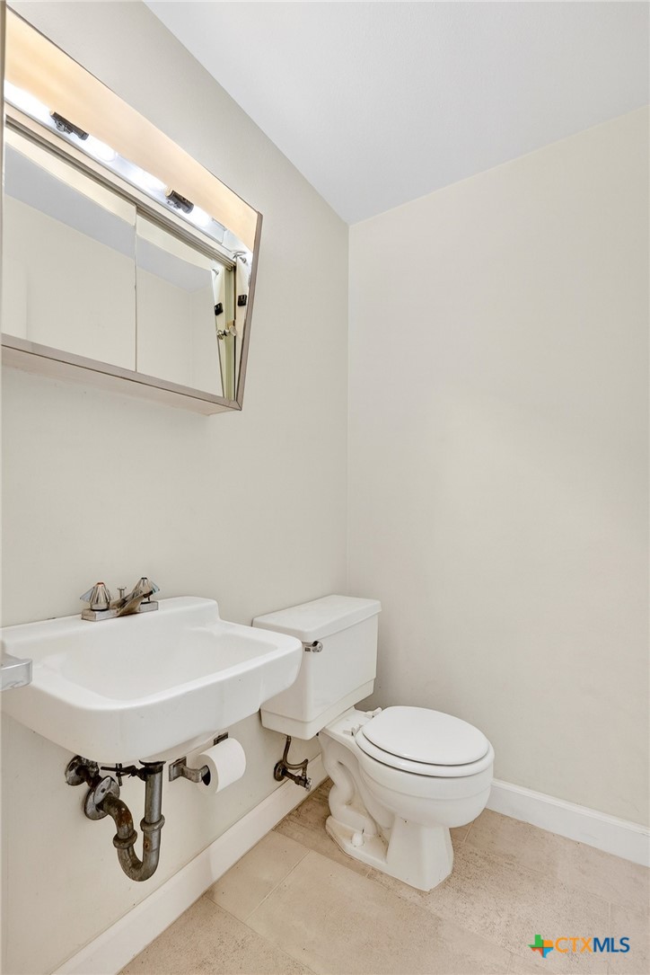 3102 Las Cruces Boulevard Temple, TX 76502 - Photo 22 of 37 a bathroom with a sink mirror and toilet