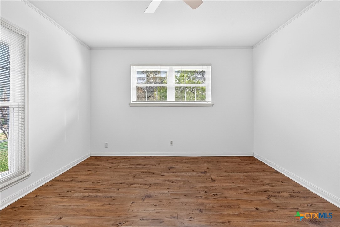 3102 Las Cruces Boulevard Temple, TX 76502 - Photo 24 of 37 an empty room with wooden floor and windows