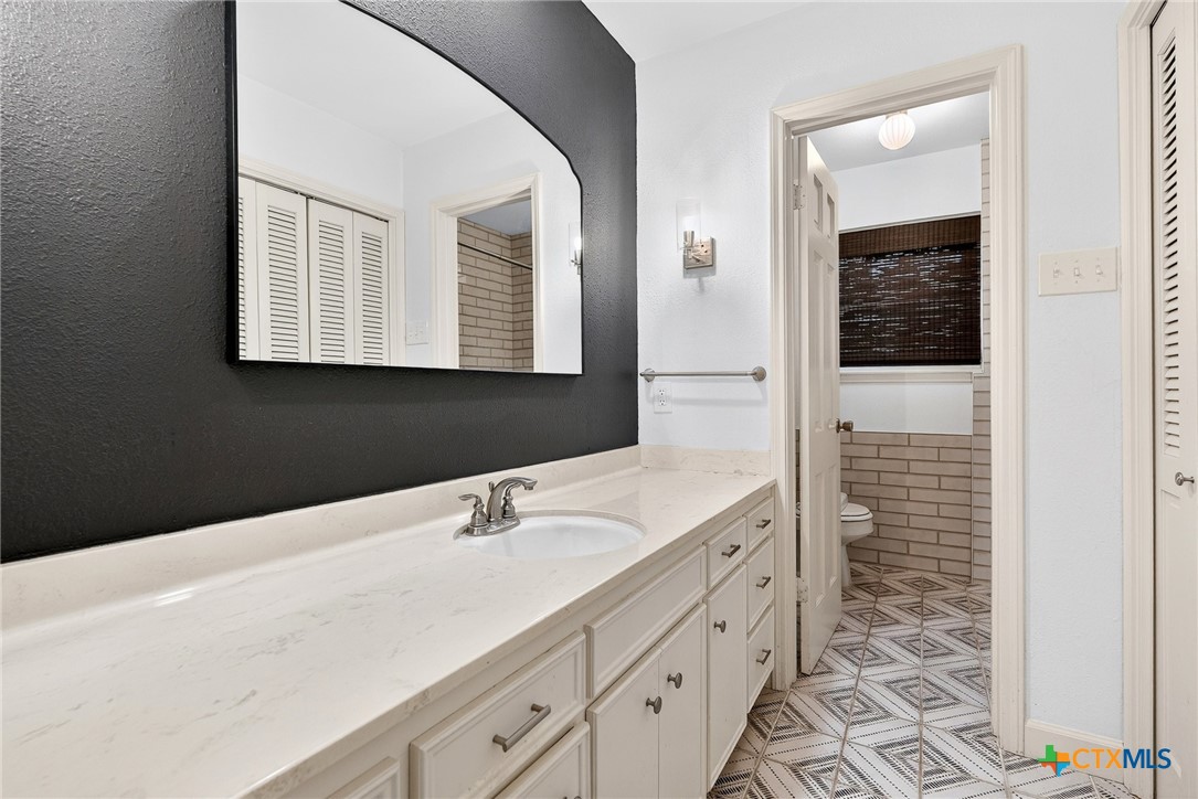 3102 Las Cruces Boulevard Temple, TX 76502 - Photo 26 of 37 a bathroom with a sink vanity and mirror