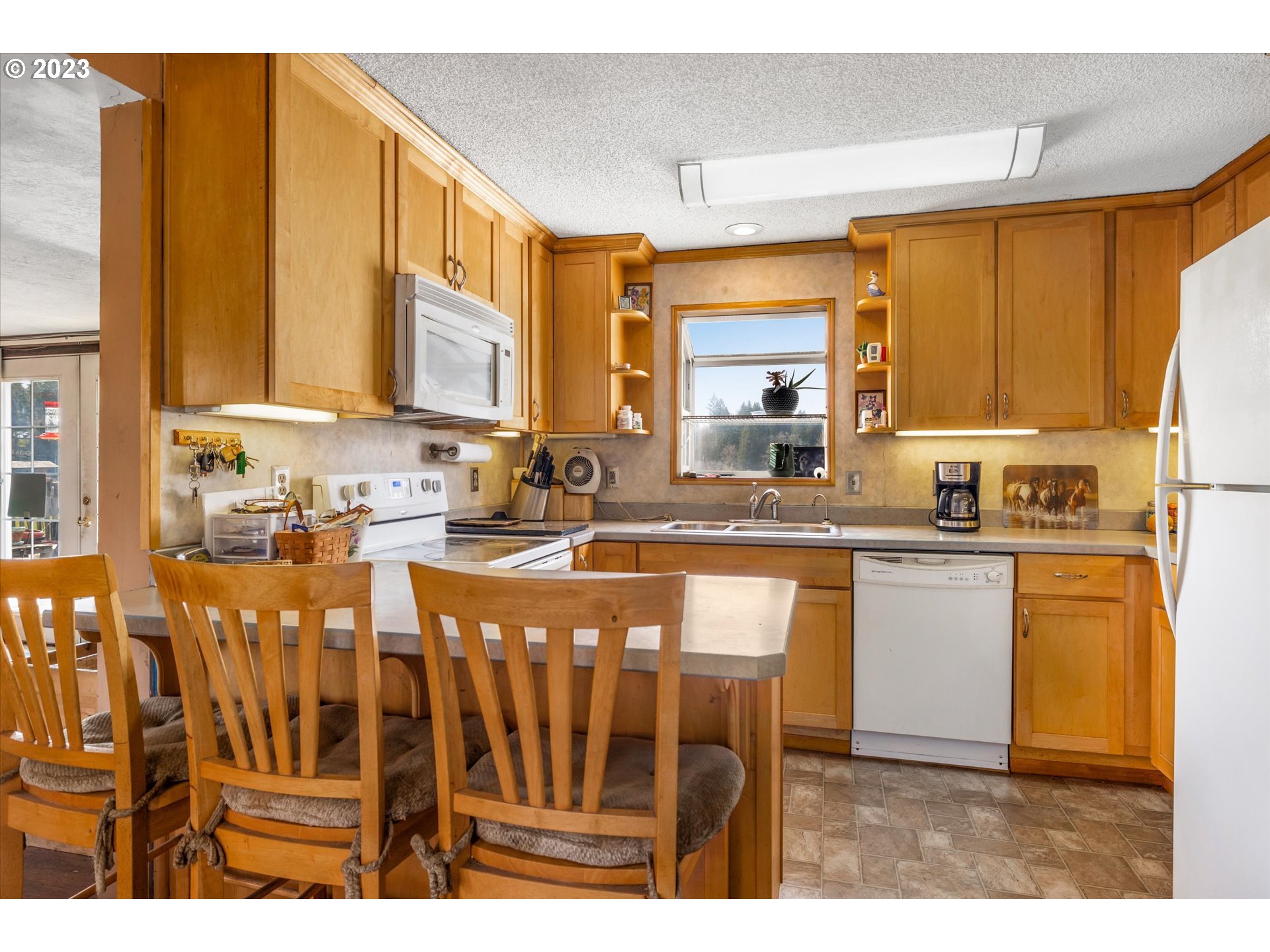 39400 Southeast Trubel Road Sandy, OR 97055 - Photo 9 of 34 a kitchen with stainless steel appliances granite countertop a stove a sink and a refrigerator