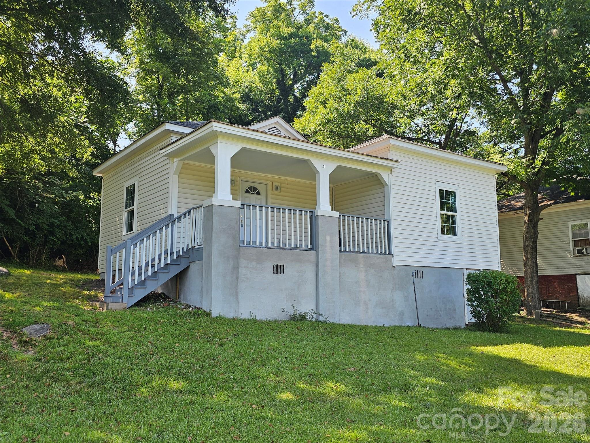 a front view of a house with a garden and deck