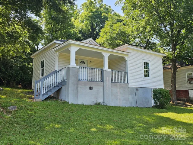 a front view of a house with a garden and deck