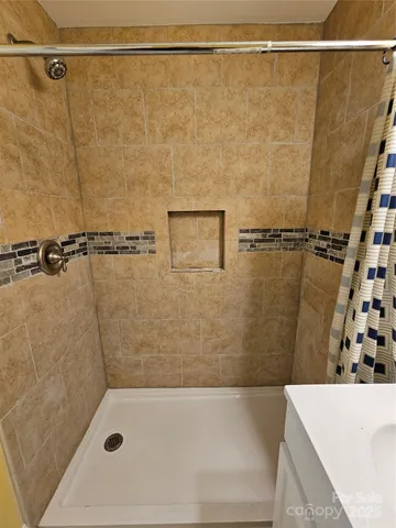 a bathroom with a shower and a shower