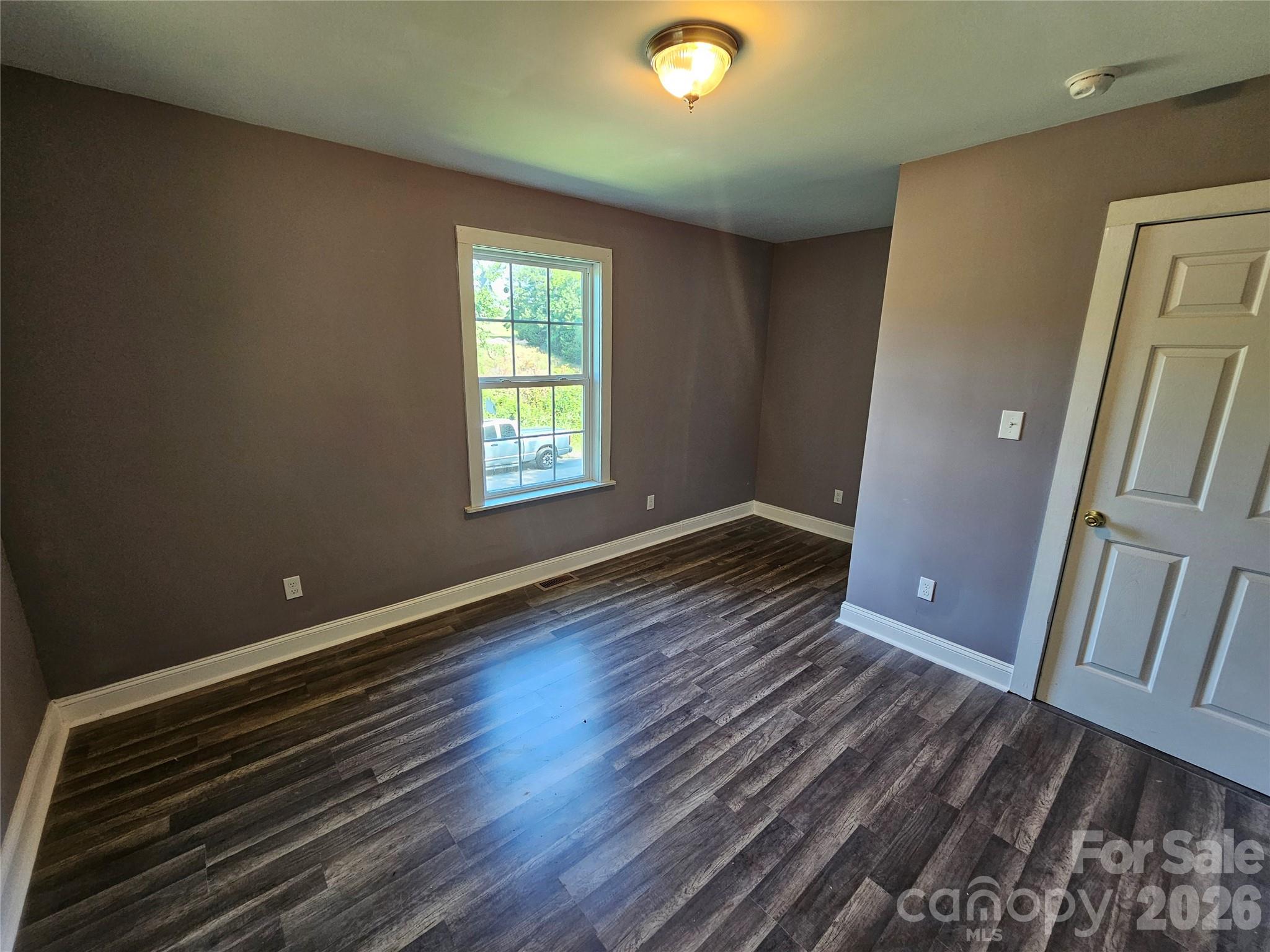 31 Poplar Street Great Falls, SC 29055 - Photo 13 of 16 a view of an empty room with wooden floor and a window