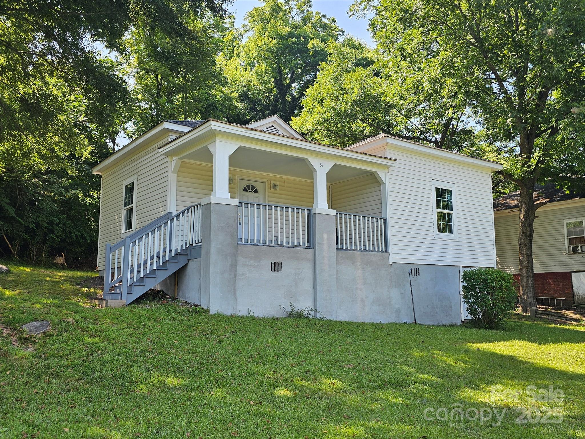 31 Poplar Street Great Falls, SC 29055 - Photo 3 of 16 a front view of a house with a garden and deck