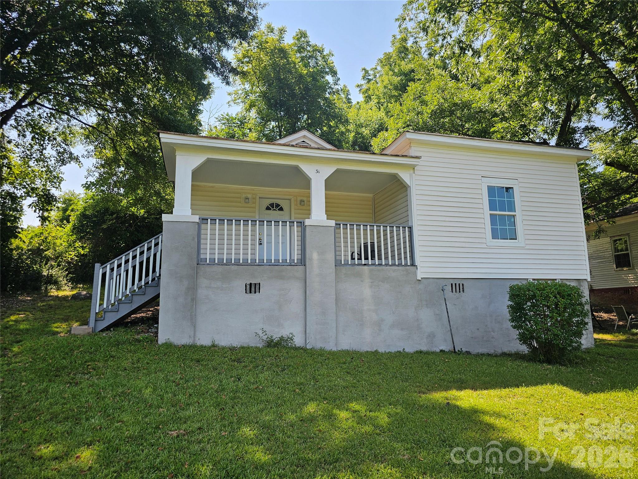 31 Poplar Street Great Falls, SC 29055 - Photo 5 of 16 a view of a house with a yard and a garden