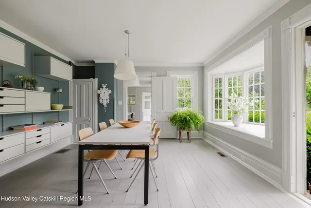 a bedroom with a bed two lamps with wooden floor