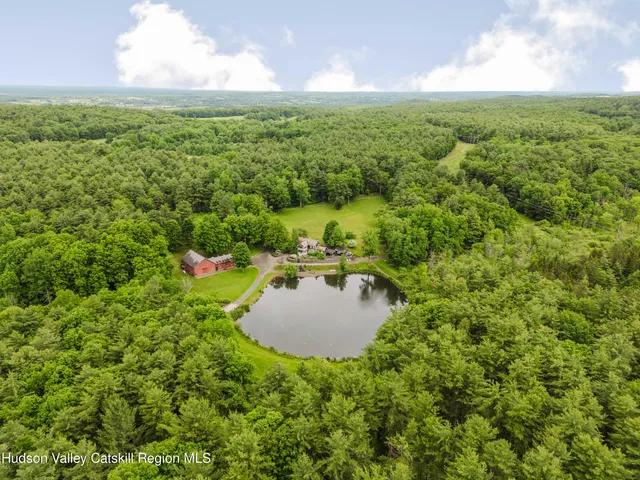 a front view of a house with a yard and potted plants