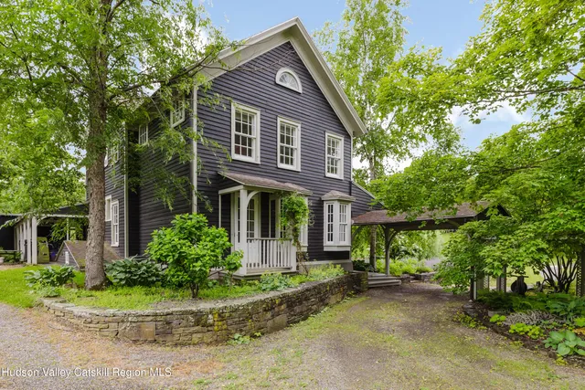a front view of a house with a yard and outdoor seating