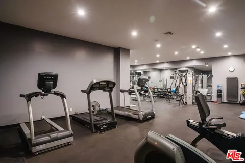 a room with gym equipment and lots of chairs