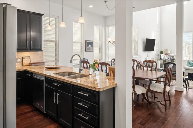 a kitchen with granite countertop a refrigerator stove and microwave
