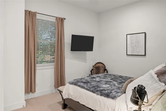 a bedroom with a bed and a chair