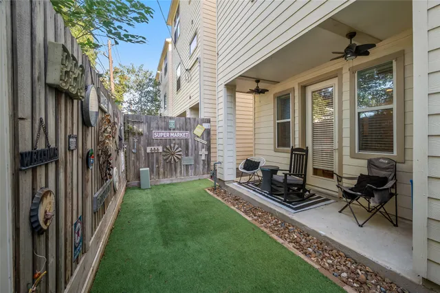 a view of backyard with a table and chairs and a barbeque
