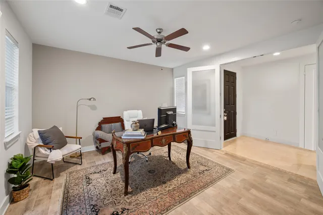 a work room with furniture and view of wooden floor