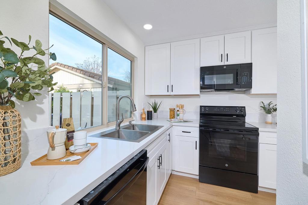 11364 Poblado Road San Diego, CA 92127 - Photo 13 of 39 a kitchen with a sink stove and microwave