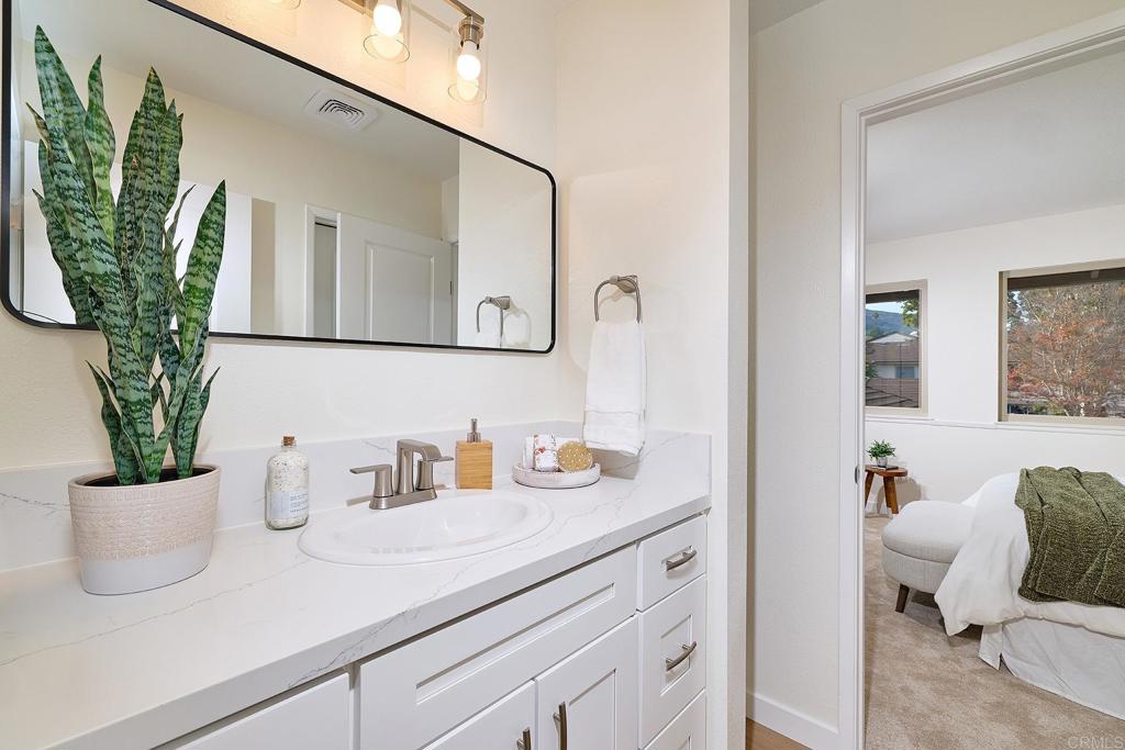 11364 Poblado Road San Diego, CA 92127 - Photo 20 of 39 a bathroom with a sink a mirror and potted plant