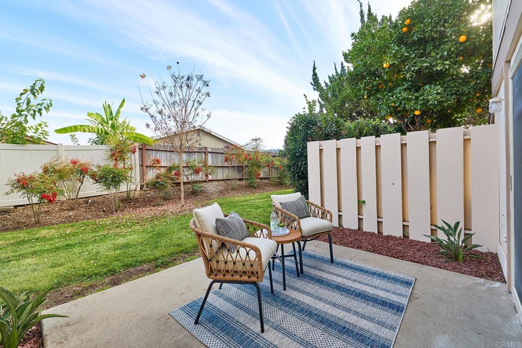 11364 Poblado Road San Diego, CA 92127 - Photo 23 of 39 a view of a chairs and table in backyard of the house