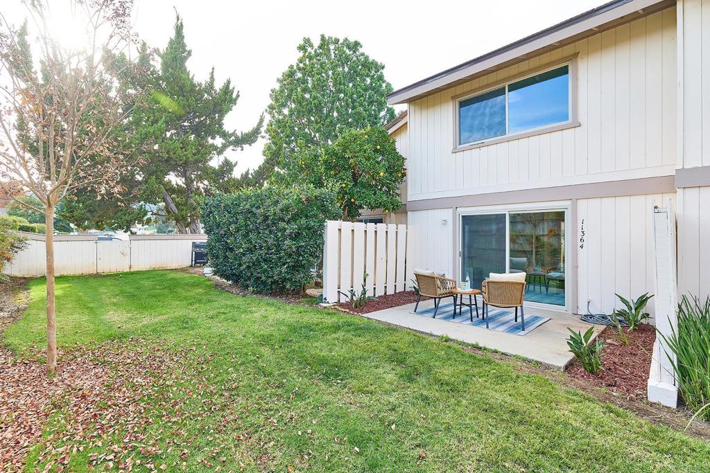 11364 Poblado Road San Diego, CA 92127 - Photo 25 of 39 a view of a backyard with table and chairs and potted plants