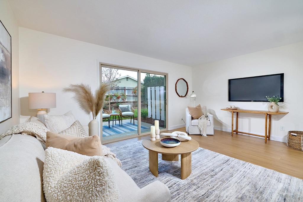11364 Poblado Road San Diego, CA 92127 - Photo 9 of 39 a living room with furniture a rug and a flat screen tv