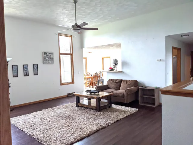 a hallway with wooden floor and livingroom view