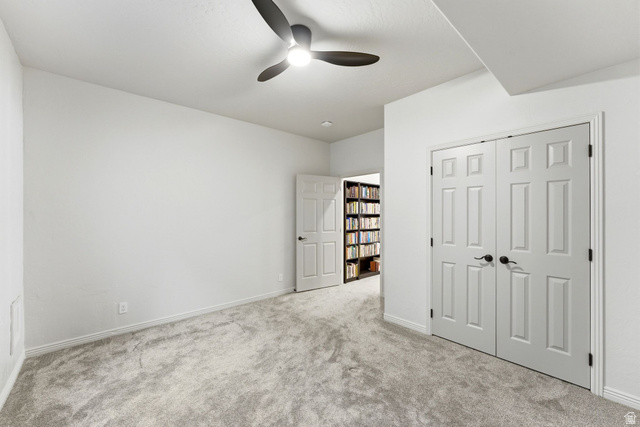 1712 Somerset Ridge Drive Draper, UT 84020 - Photo 64 of 76 Room featuring light gray patterned carpet, white walls, a ceiling fan with integrated lighting, and white six-panel bifold doors with black hardware