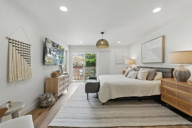 a living room with a bed furniture and a large window