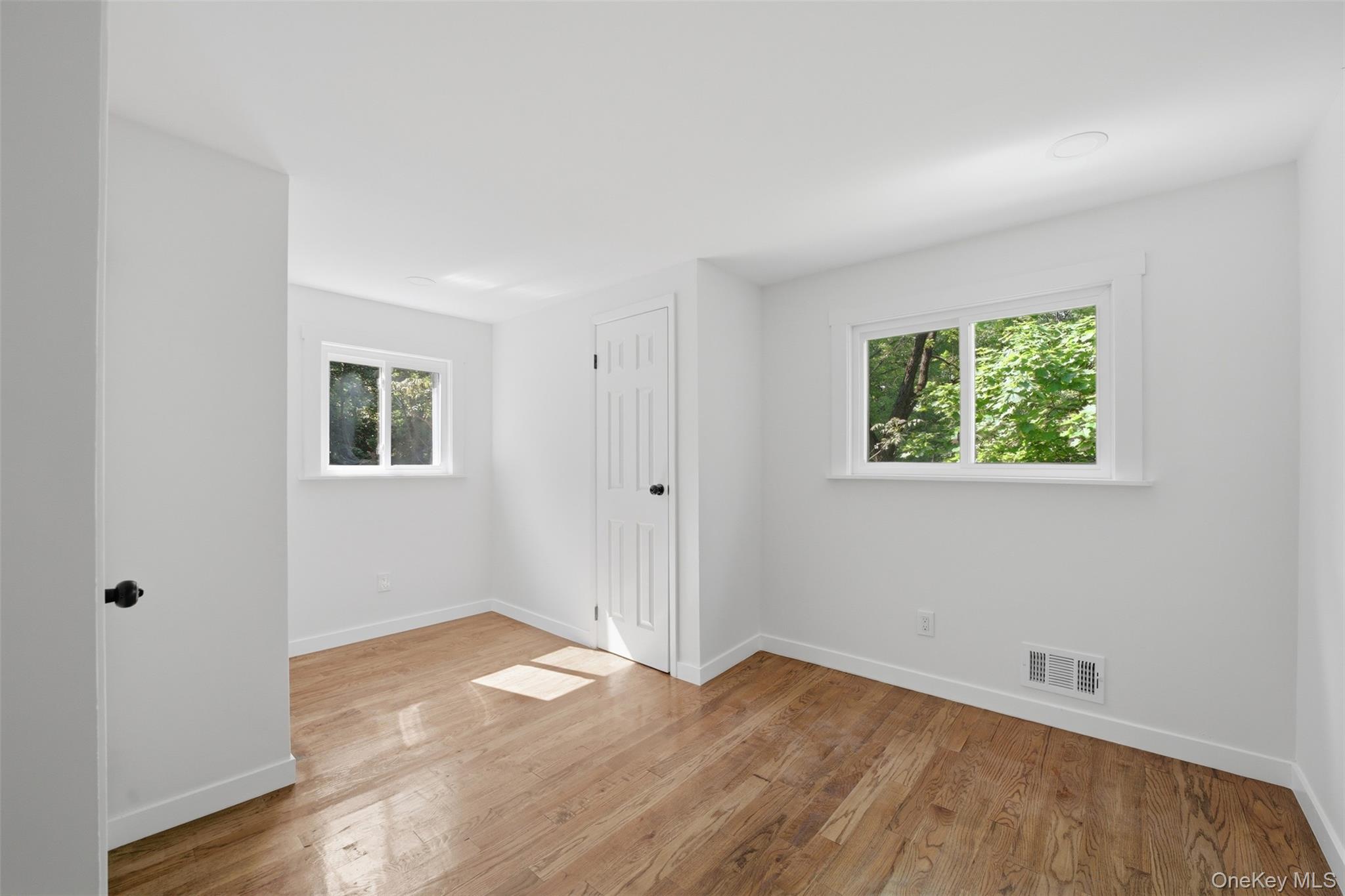 24 Fuller Road Ossining, NY 10562 - Photo 29 of 48 an empty room with wooden floor and windows