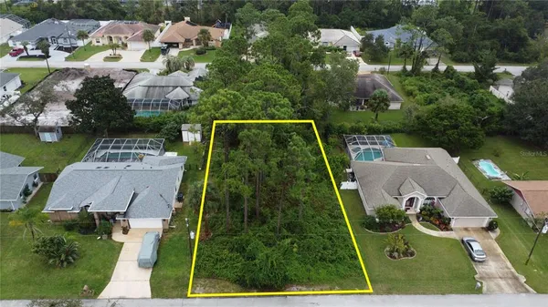 an aerial view of house with swimming pool patio and outdoor seating