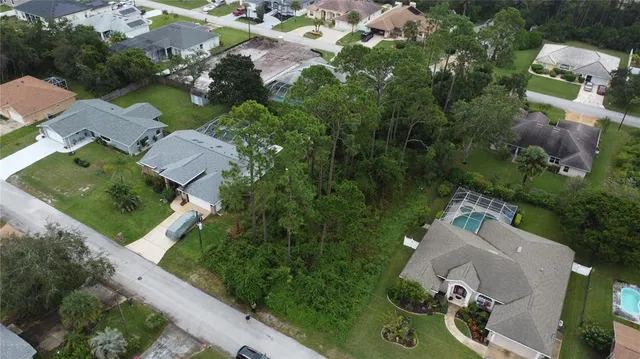 an aerial view of a house with a garden and swimming pool