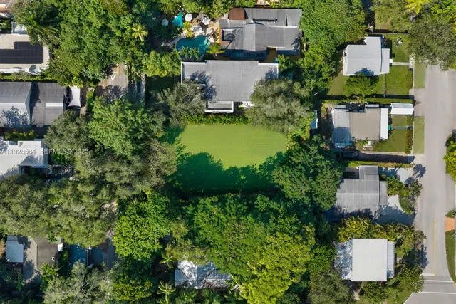 an aerial view of a house with a yard and lake view