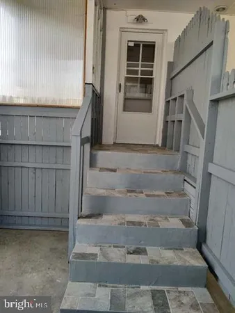 a kitchen with a refrigerator and cabinets