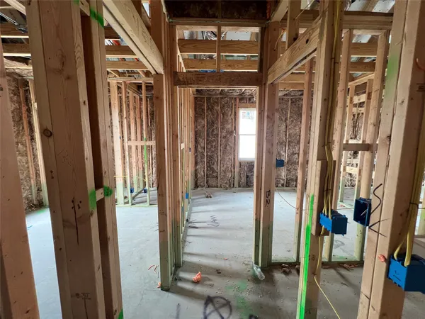 a view of a hallway with a door and couch