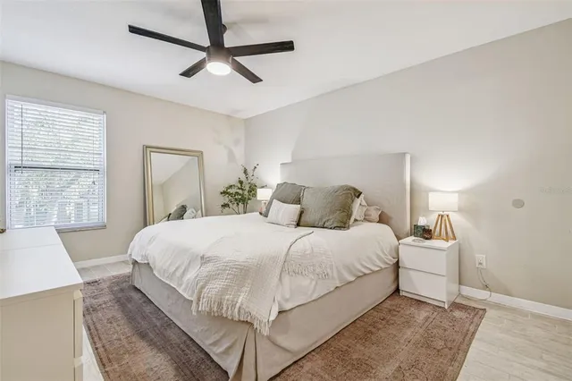 a bedroom with a large bed and a large window